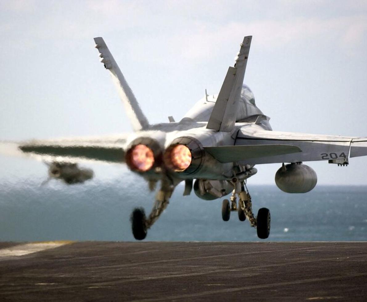 Fighter jet with after burner taking of a fighter dek ship